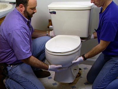 Men installing toilet