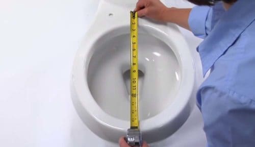 Person measuring toilet seat