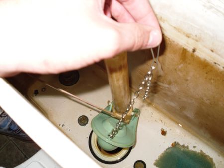 Person holding flush chain