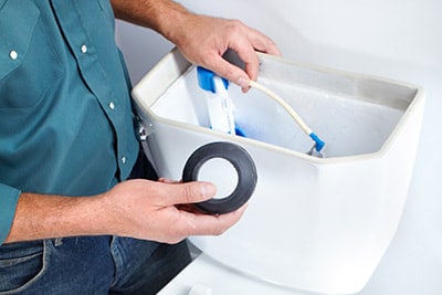 Man replacing fill valve
