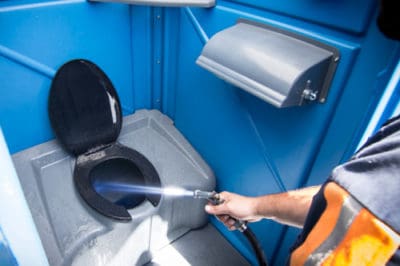 Person spraying water to the outdoor cubicle